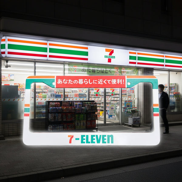 White Japanese 7-Eleven konbini license plate frame with Japanese text