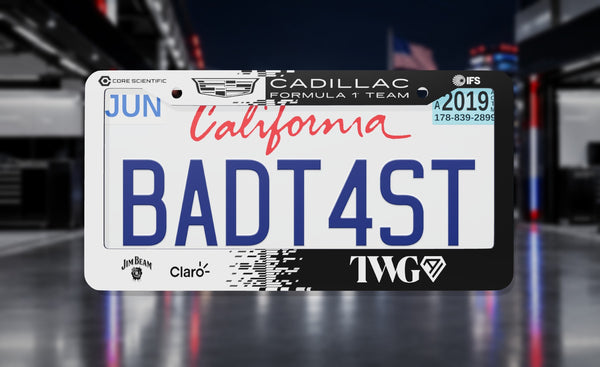 Cadillac Formula 1 Team (2026) license plate frame in black and white with the Cadillac crest and team sponsor logos, front view in a night-time F1 paddock