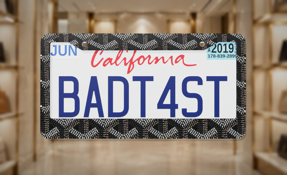Gd (Black) license plate frame on a themed background