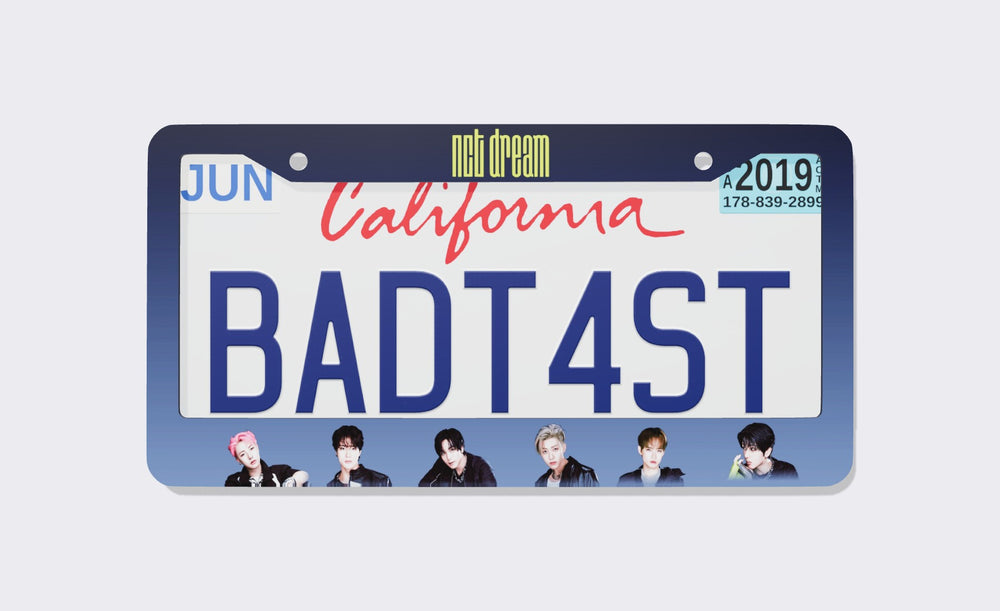 NCT DREAM license plate frame front view: navy-to-periwinkle gradient frame with the yellow nct dream logo on top and six member portraits along the bottom, shown on a California plate