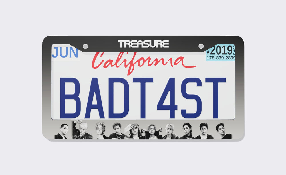 TREASURE license plate frame with white TREASURE logo on a black-to-silver gradient border and ten black and white member portraits along the bottom, shown around a California demo plate