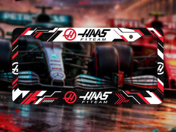 Black, red and white Haas F1 Team license plate frame in front of F1 cars on a wet track