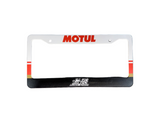 License plate frame with 'MOTUL' branding on a gray surface