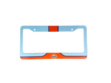 Blue and orange license plate frame on a gray surface