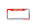 License plate frame with Nissan and Xanavi branding on a gray surface