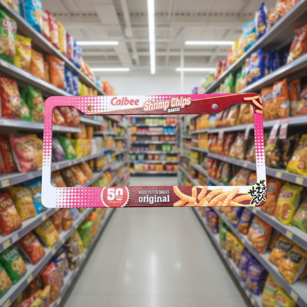 Pink and red Calbee Shrimp Chips license plate frame shown in a snack aisle