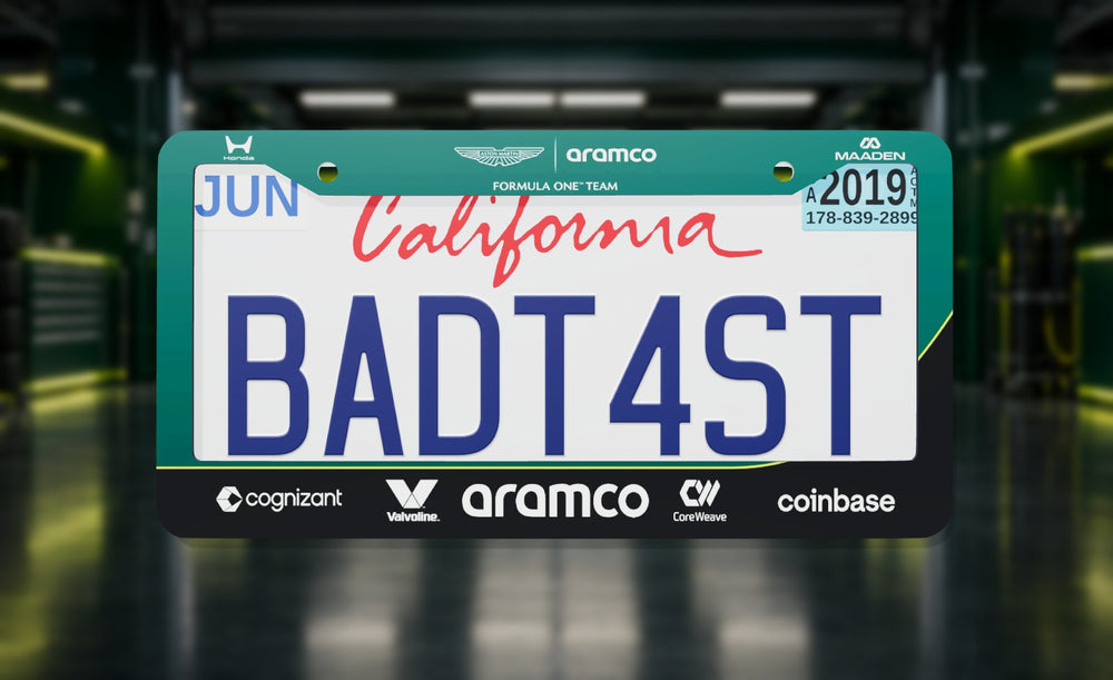Aston Martin Formula 1 Team (2026) license plate frame in green with the Aston Martin, Aramco and team sponsor logos, front view in a racing-green F1 pit garage