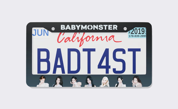 Dark slate BABYMONSTER license plate frame with the white logo on top and seven members along the bottom