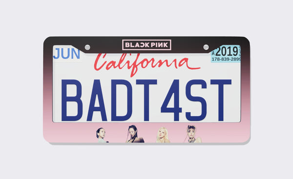 BLACKPINK license plate frame, 2026 edition, front view: black-to-pink gradient frame with the BLACKPINK logo on top and member portraits along the bottom, shown on a California plate