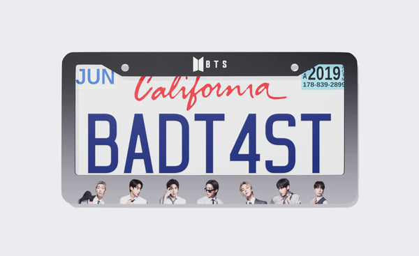 BTS license plate frame, 2026 edition, front view: black-to-grey gradient frame with the BTS logo on top and member portraits along the bottom, shown on a California plate