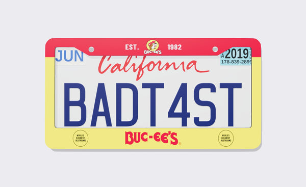 Buc-ee's Official license plate frame, front view: yellow frame with a red top band reading Est. 1982 around the Buc-ee's beaver logo, a red Buc-ee's wordmark on the bottom flanked by World's Cleanest Restrooms badges