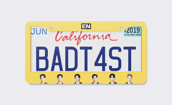 ENHYPEN license plate frame front view: yellow frame with the black EN logo on top and six member portraits along the bottom, shown on a California plate