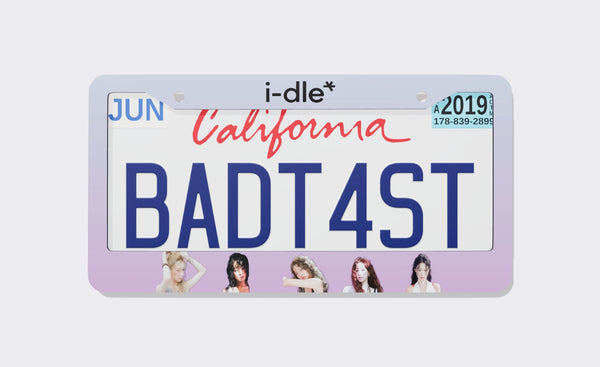 Pastel lavender i-dle license plate frame with the logo on top and five members along the bottom