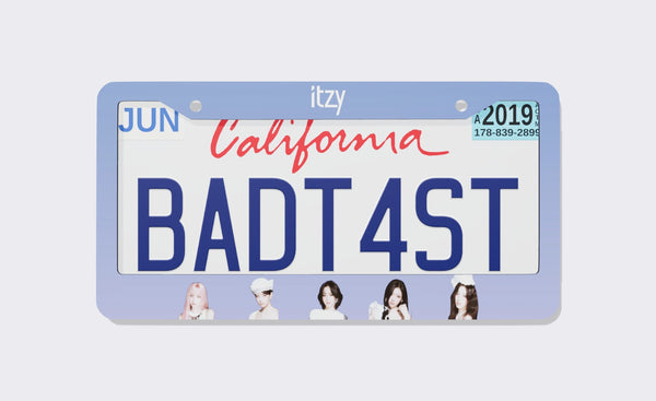 ITZY license plate frame, 2026 edition, front view: periwinkle gradient frame with the ITZY logo on top and member portraits along the bottom, shown on a California plate