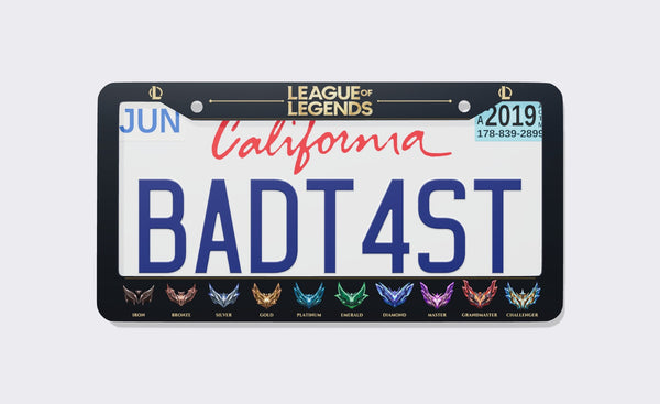 Black League of Legends Ranks license plate frame with gold League of Legends logo on top and all ten rank emblems from Iron to Challenger along the bottom, front view