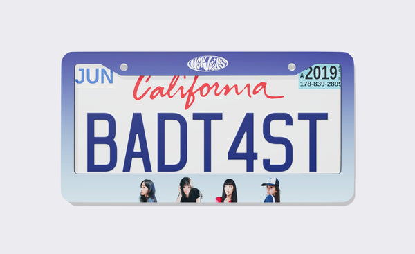 NewJeans license plate frame, 2026 edition, front view: indigo-to-light-blue gradient frame with the NewJeans oval logo on top and member portraits along the bottom, shown on a California plate