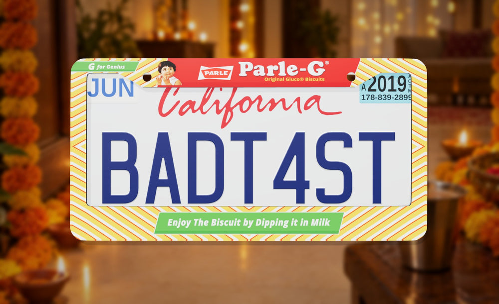 Parle-G license plate frame with yellow stripes, the Parle-G logo and the Parle-G girl, front view on a Diwali lamp-lit home background