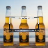 White Corona beer license plate frame with bottles on a beach at sunset
