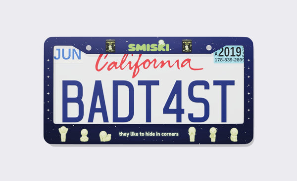 Smiski license plate frame, front view: starry navy night-sky frame with the green Smiski logo and blind boxes on top, glowing Smiski figures posing along the bottom and the line they like to hide in corners