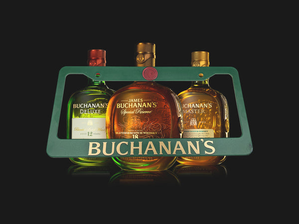 Teal Buchanan's whisky license plate frame with three whisky bottles on a black background