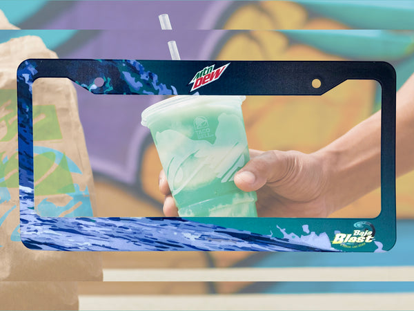Dark blue Mountain Dew Baja Blast license plate frame with a hand holding a drink cup